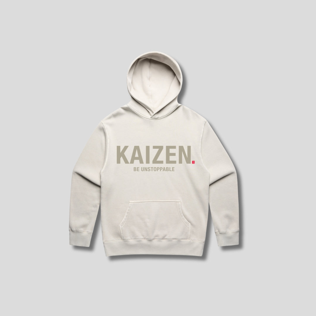 Bone hoodie with 'KAIZEN' text, folded flat on grey background