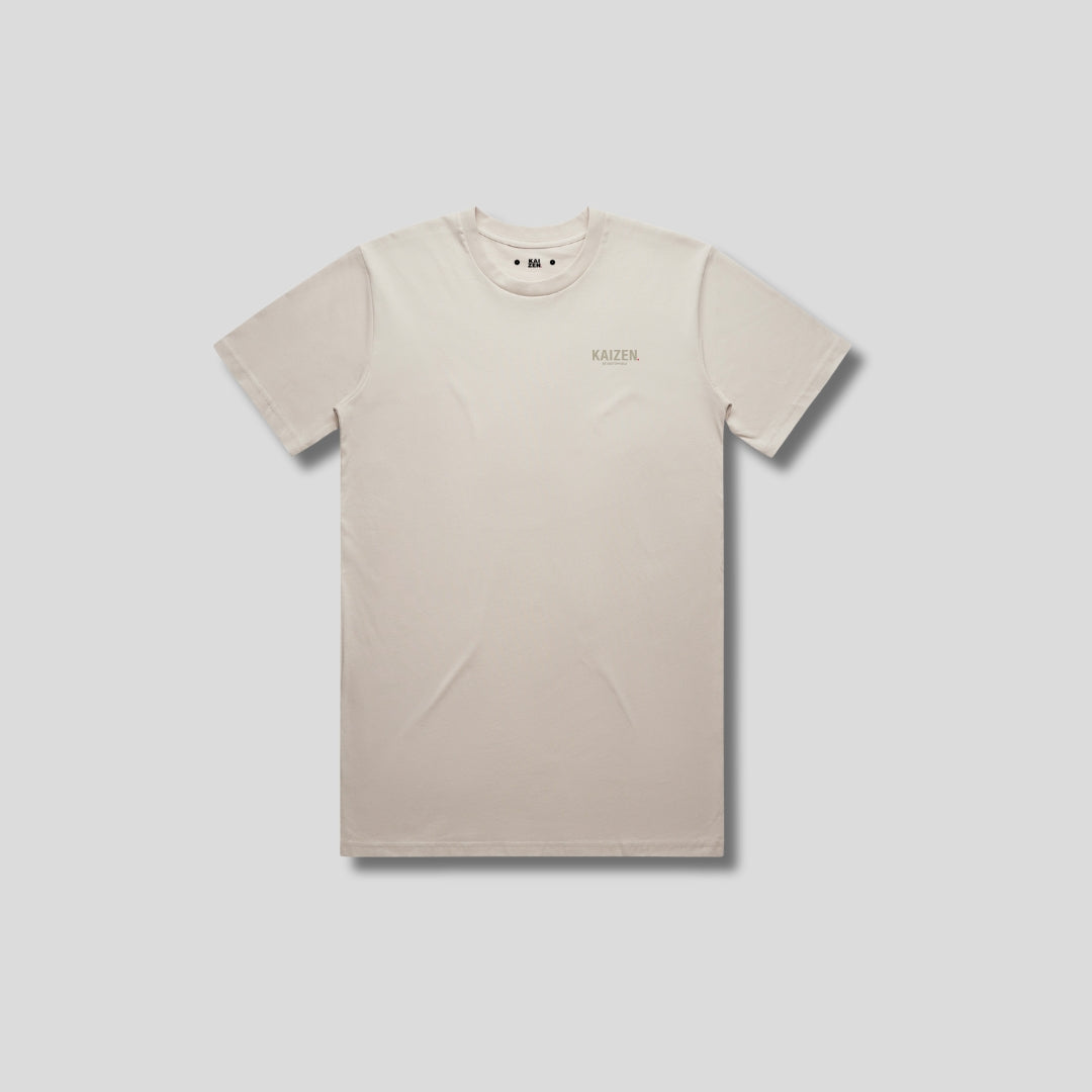 Bone t-shirt with 'KAIZEN' logo, flat lay on neutral background