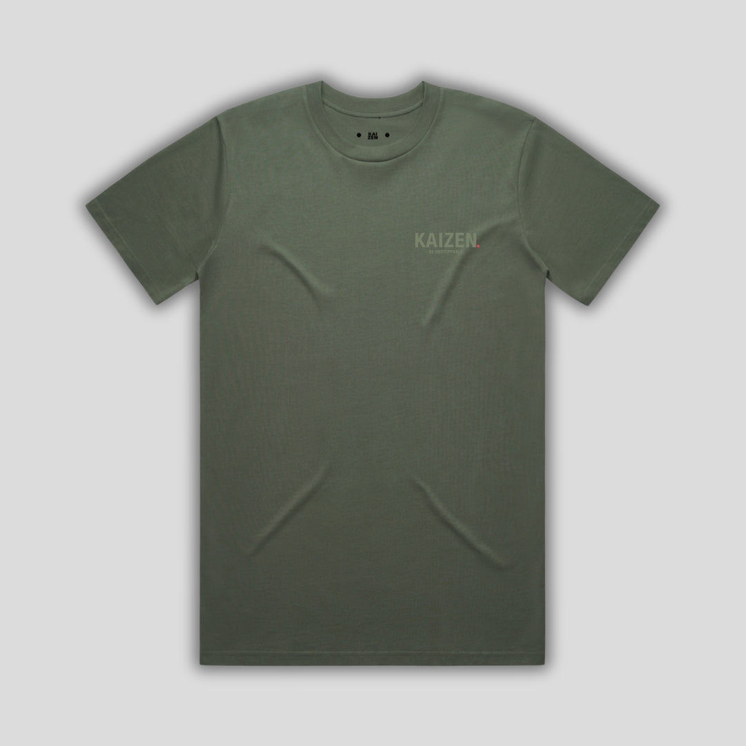 Green t-shirt with 'KAIZEN' logo, flat lay on neutral background