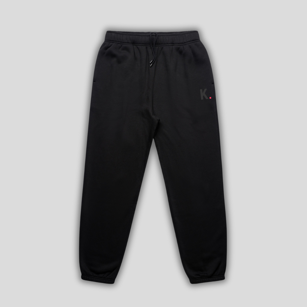 Black joggers with 'KAIZEN' logo, flat lay product image