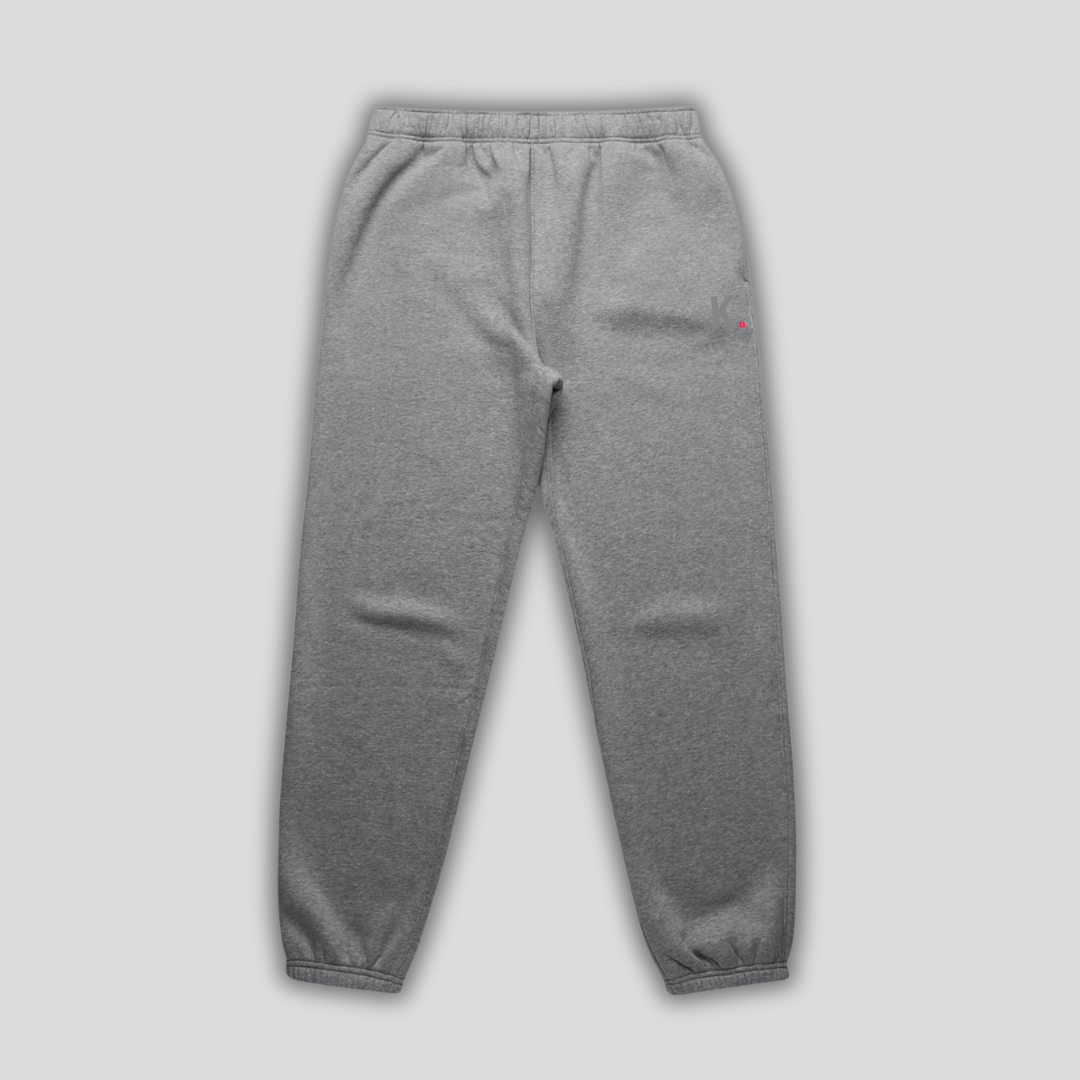 Grey joggers with 'KAIZEN' logo, flat lay product image