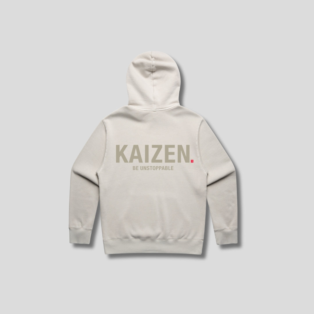 Bone hoodie with 'KAIZEN' text, folded flat on grey background