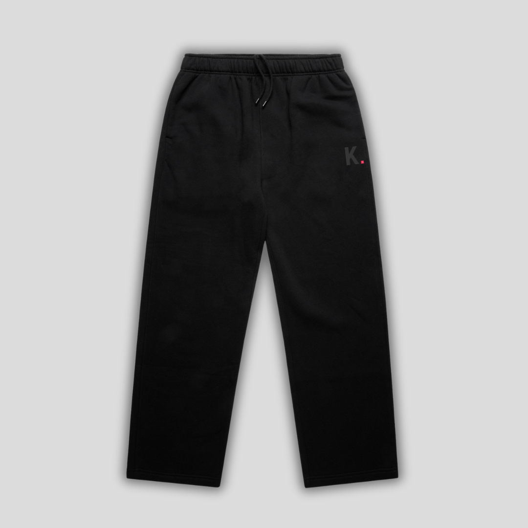 Black straight leg joggers with 'KAIZEN' logo, flat lay product image