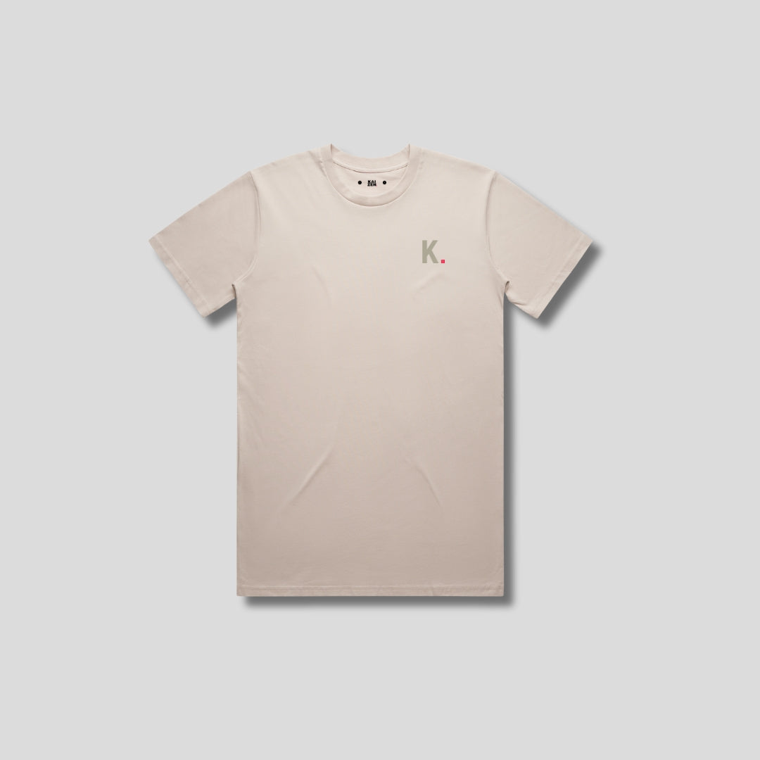 Bone t-shirt with 'KAIZEN' logo, flat lay on neutral background