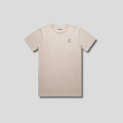 Bone t-shirt with 'KAIZEN' logo, flat lay on neutral background