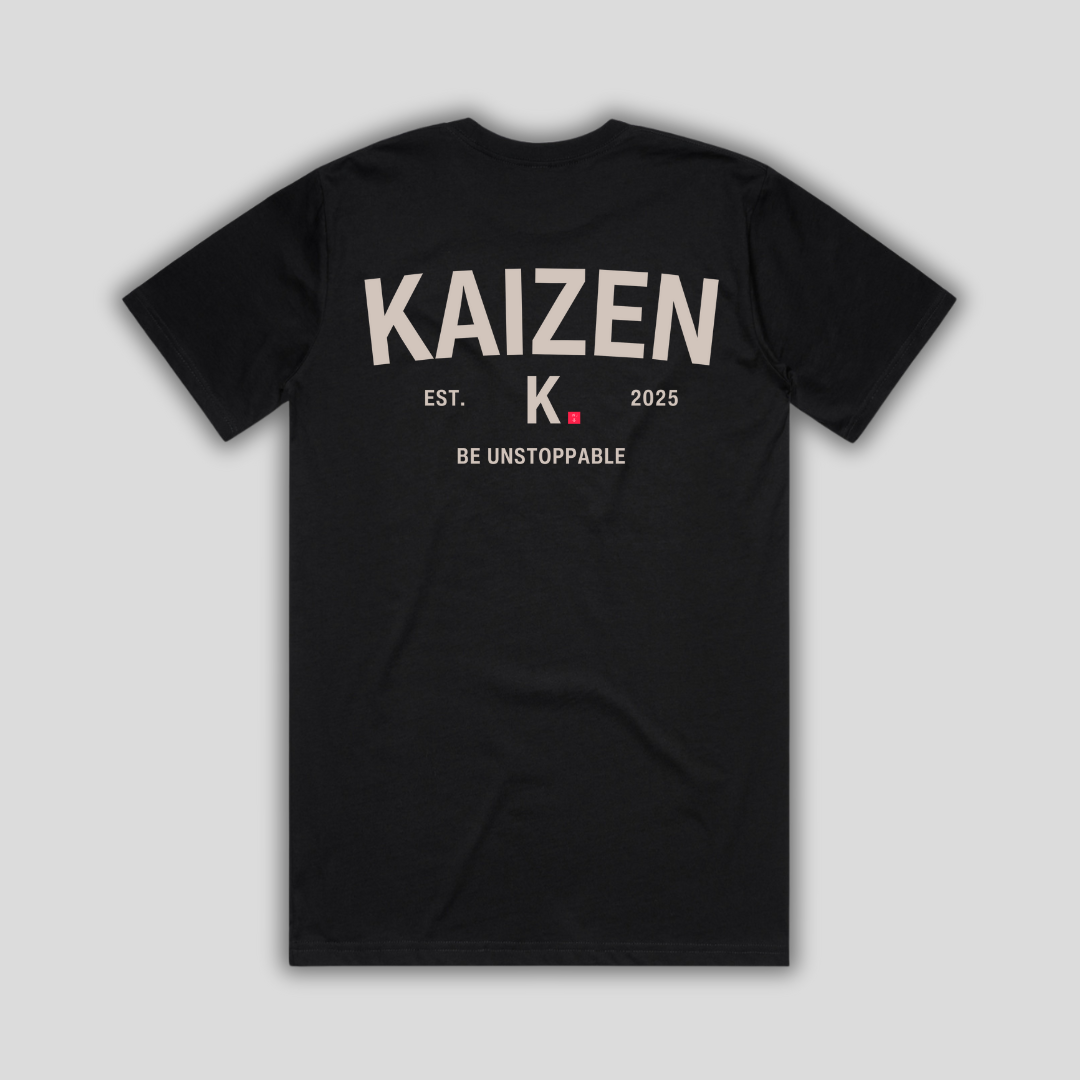 Black t-shirt with 'KAIZEN' logo, flat lay on neutral background