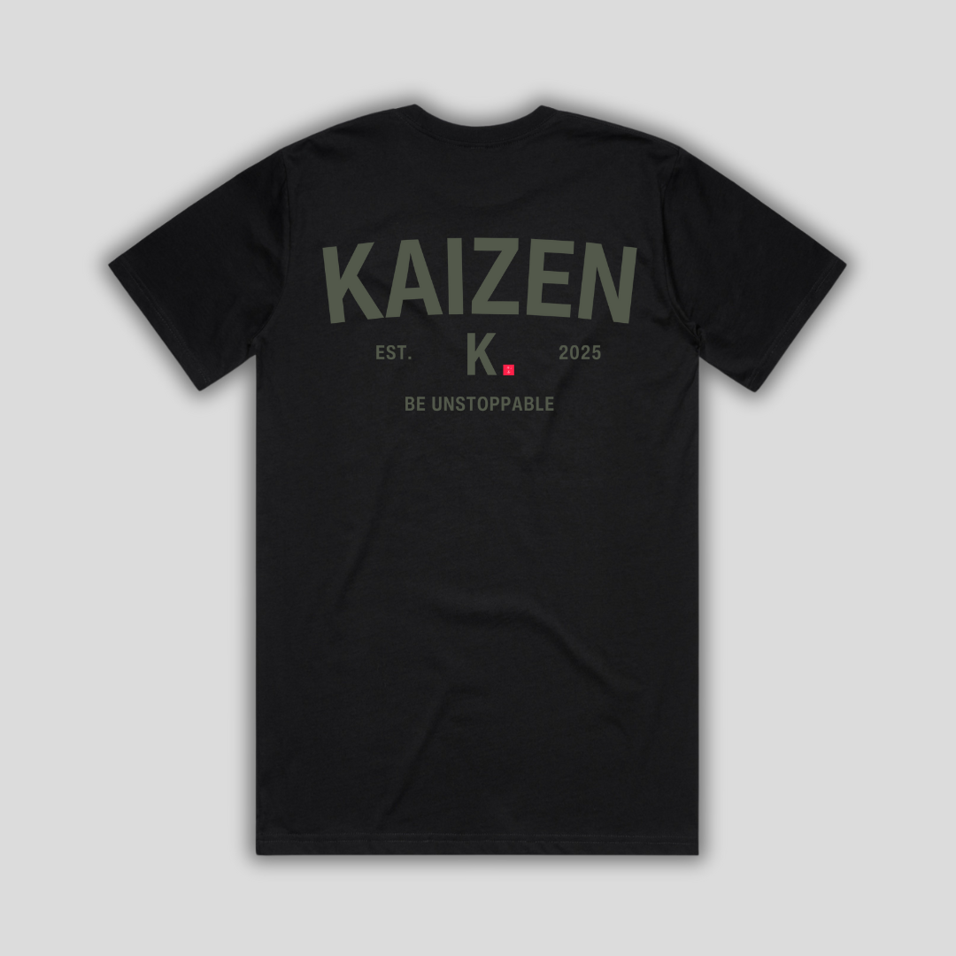 Black t-shirt with 'KAIZEN' logo, flat lay on neutral background