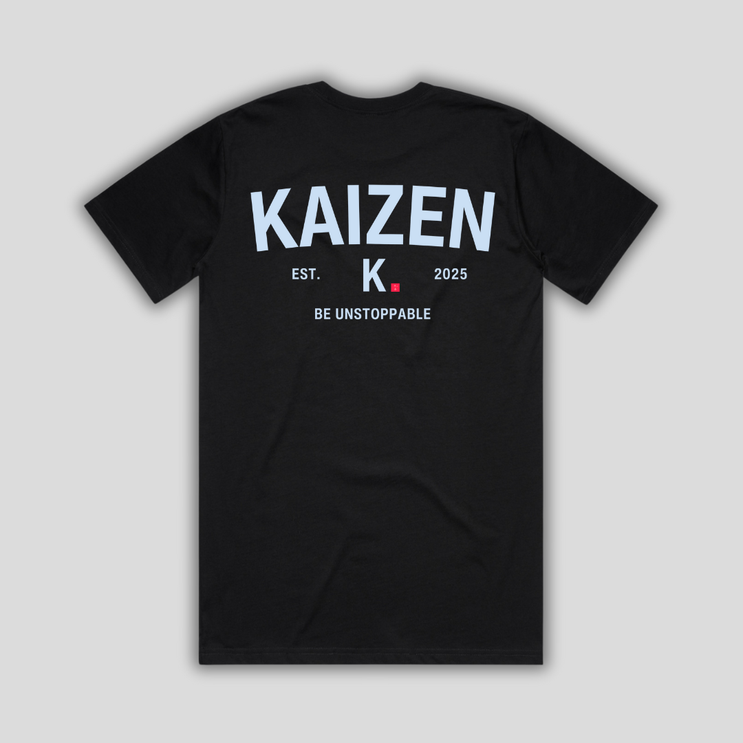 Black t-shirt with 'KAIZEN' logo, flat lay on neutral background