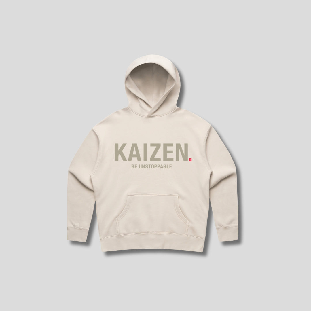 Bone hoodie with 'KAIZEN' text, folded flat on grey background