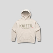 Bone hoodie with 'KAIZEN' text, folded flat on grey background
