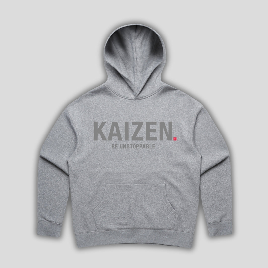 Grey hoodie with 'KAIZEN' text, folded flat on grey background