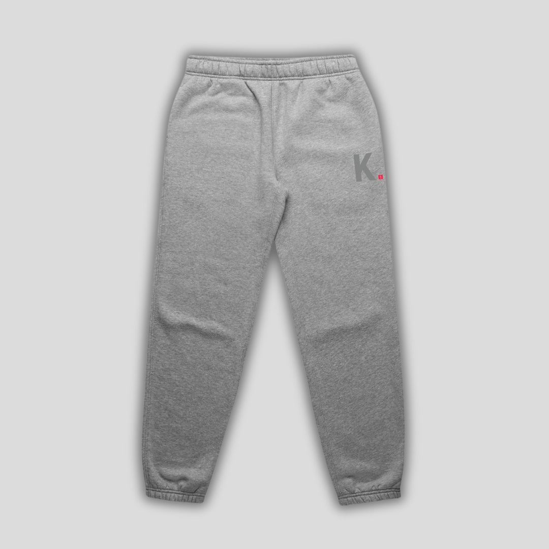 Grey joggers with 'KAIZEN' logo, flat lay product image