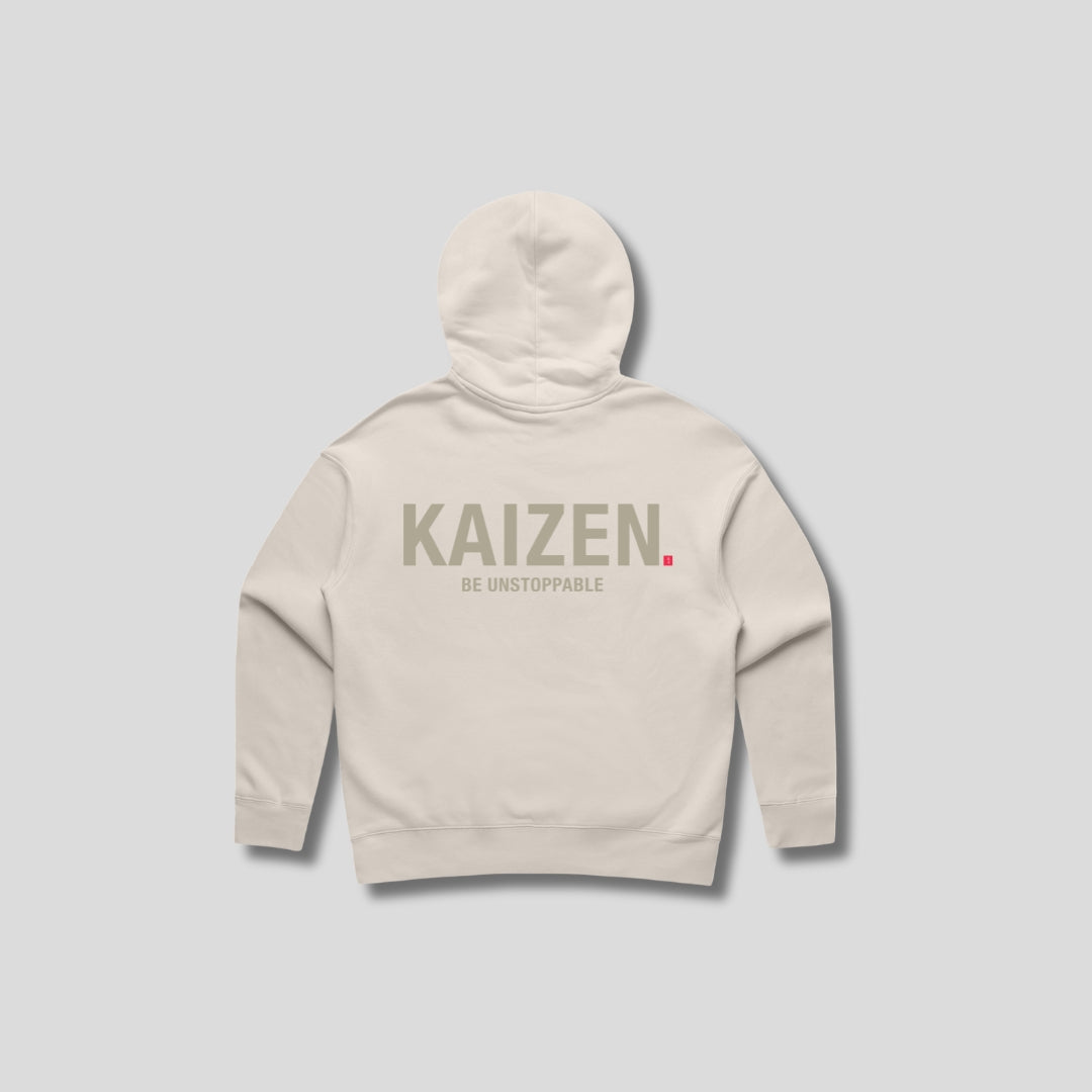 Bone hoodie with 'KAIZEN' text, folded flat on grey background