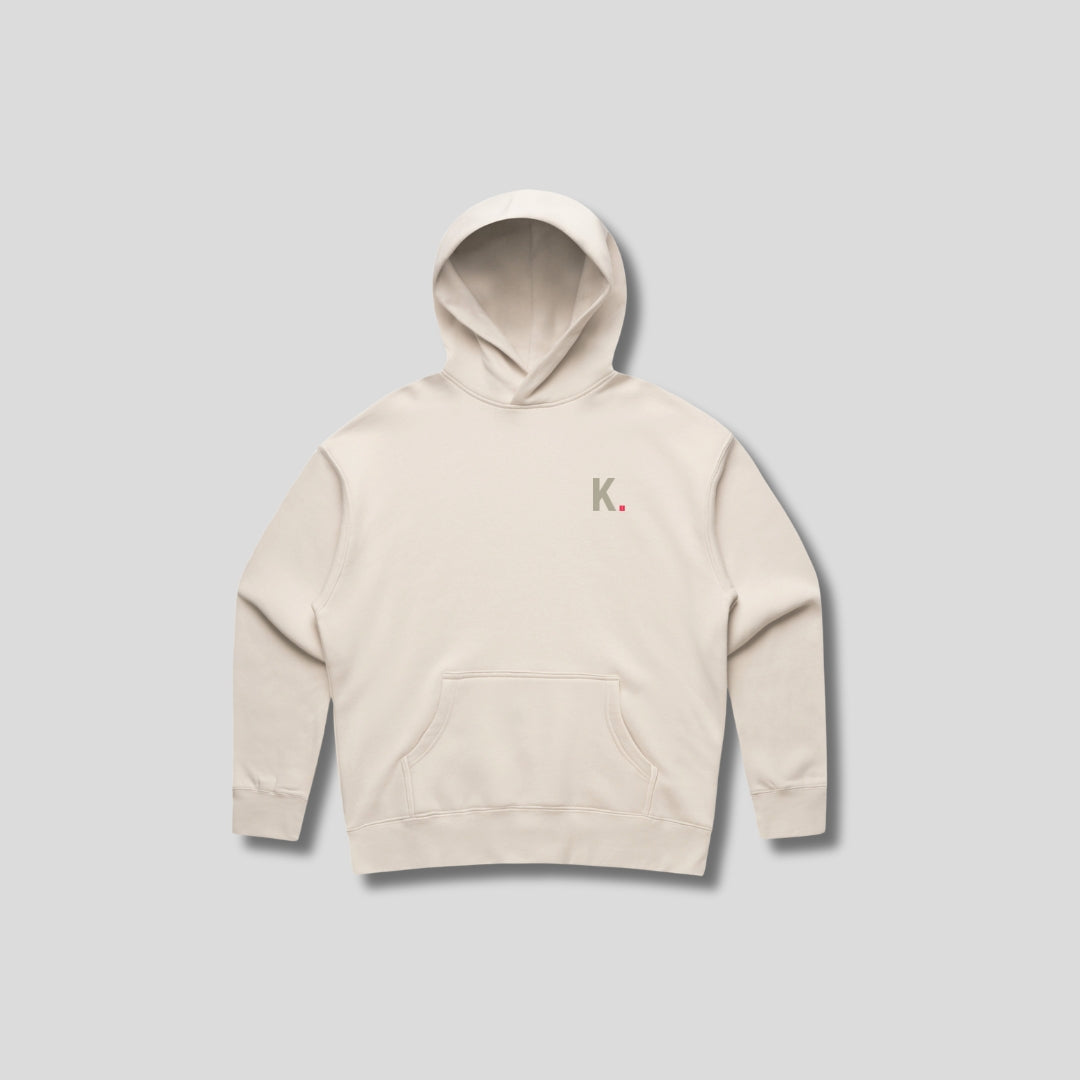 Bone hoodie with 'KAIZEN' text, folded flat on grey background