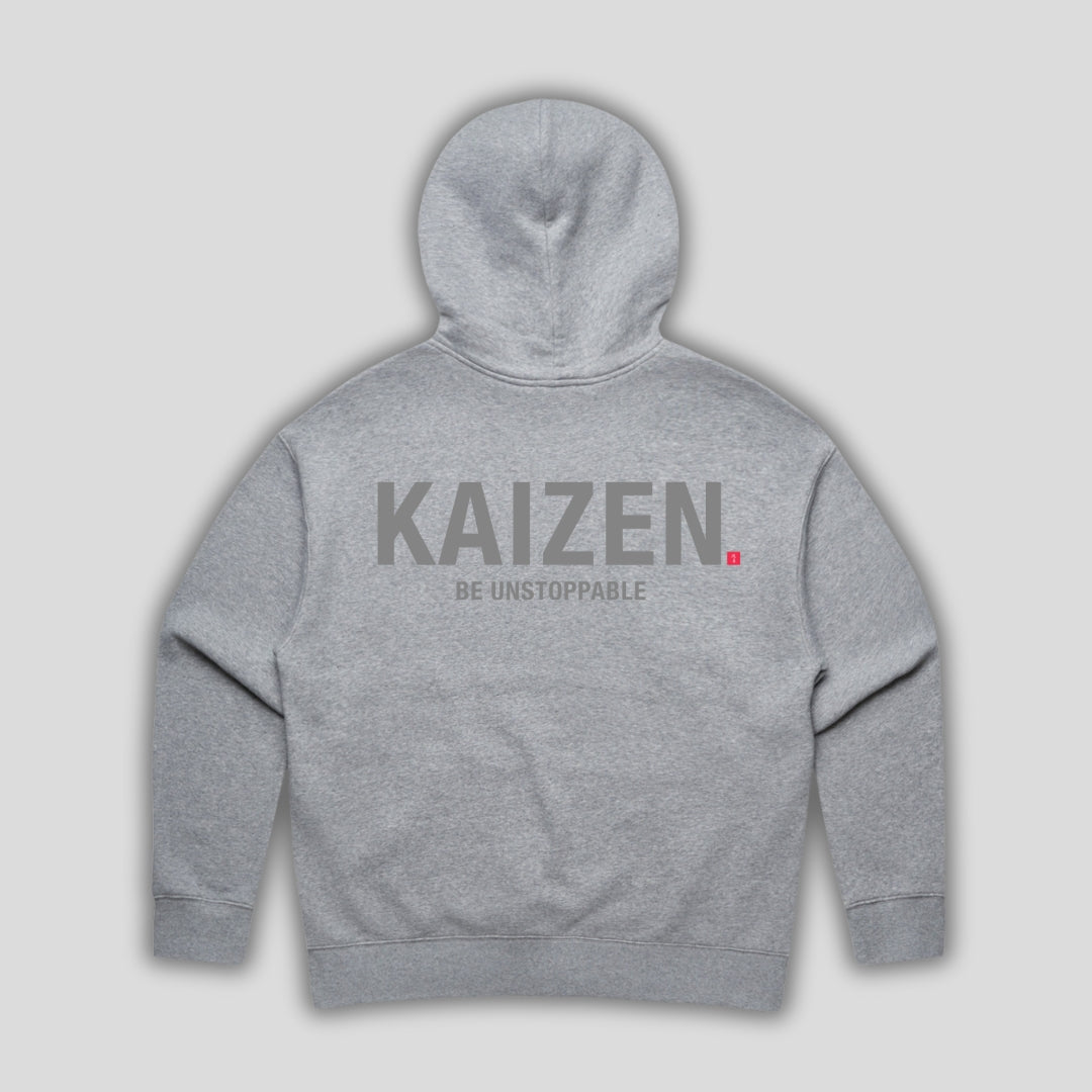 Grey hoodie with 'KAIZEN' text, folded flat on grey background